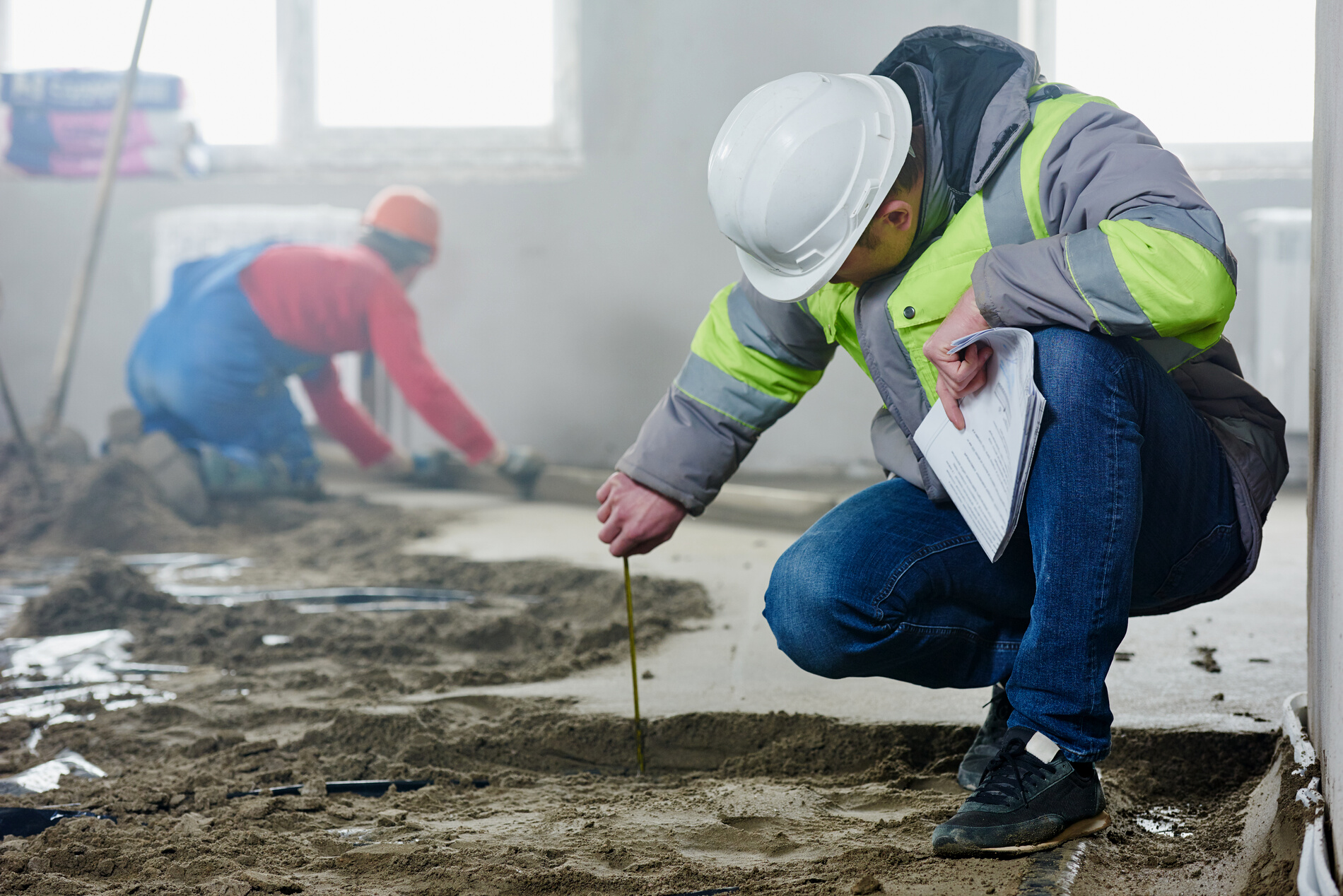 Foreman Builder Inspecting Concrete